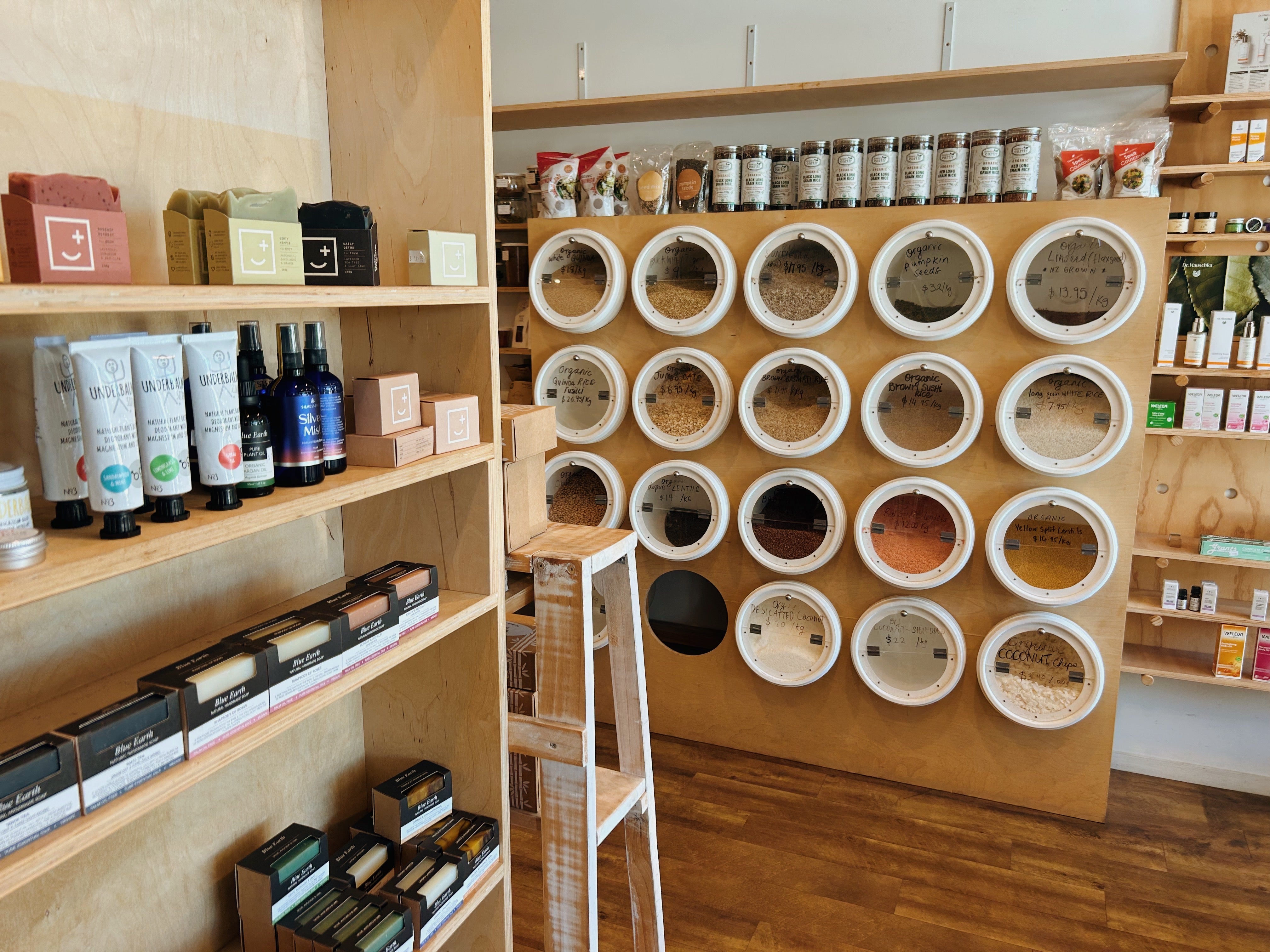Inside Be Organics store in Mt Maunganui. Products on shelves and bulk food containers lining a wall.