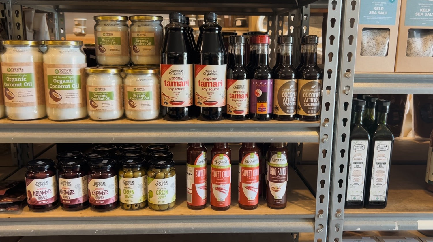 Be Organics shelf with jars of tamari and coconut oil.