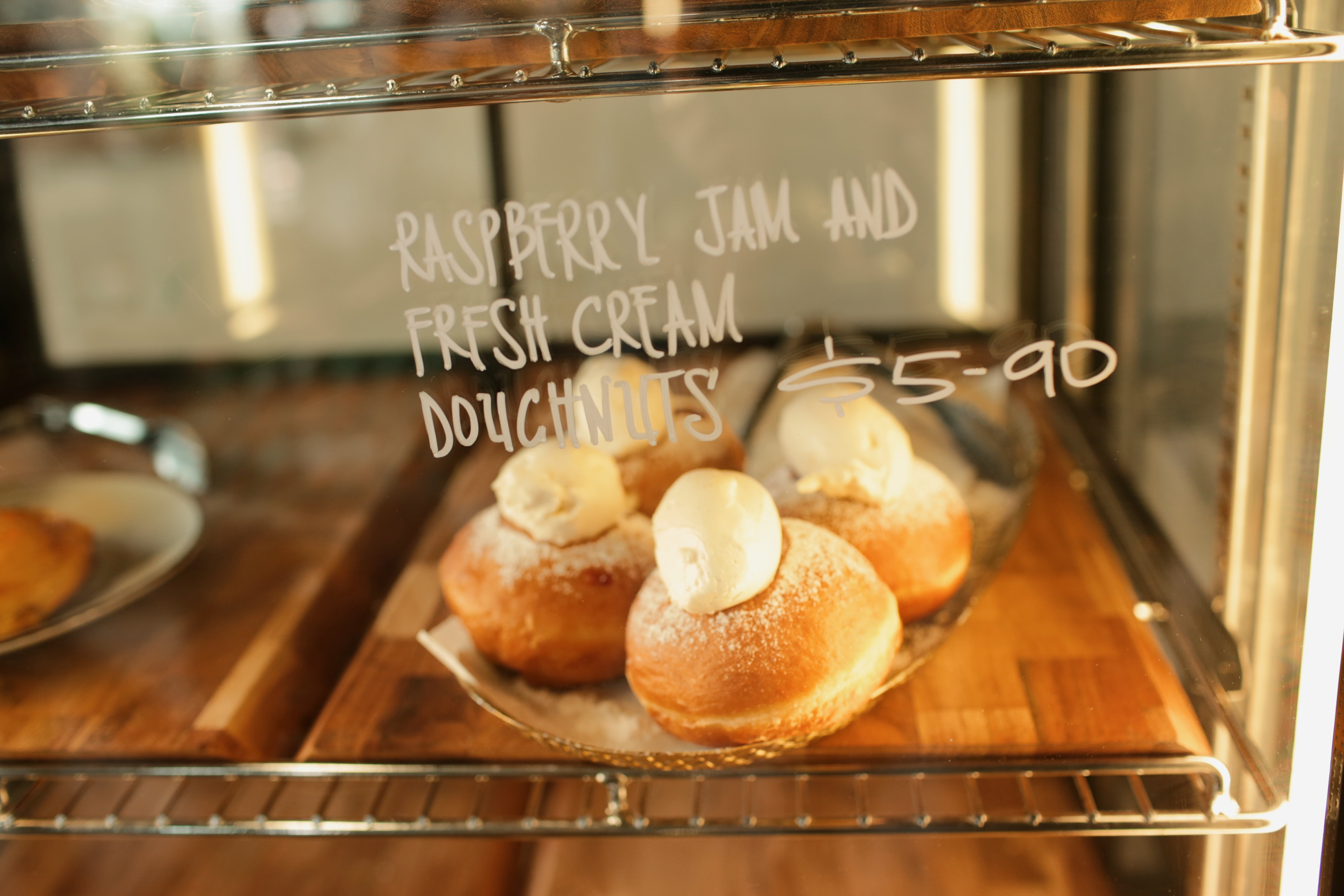 Volare Donuts filled with Raspberry Jam and fresh cream in the Te Puna Deli cabinet