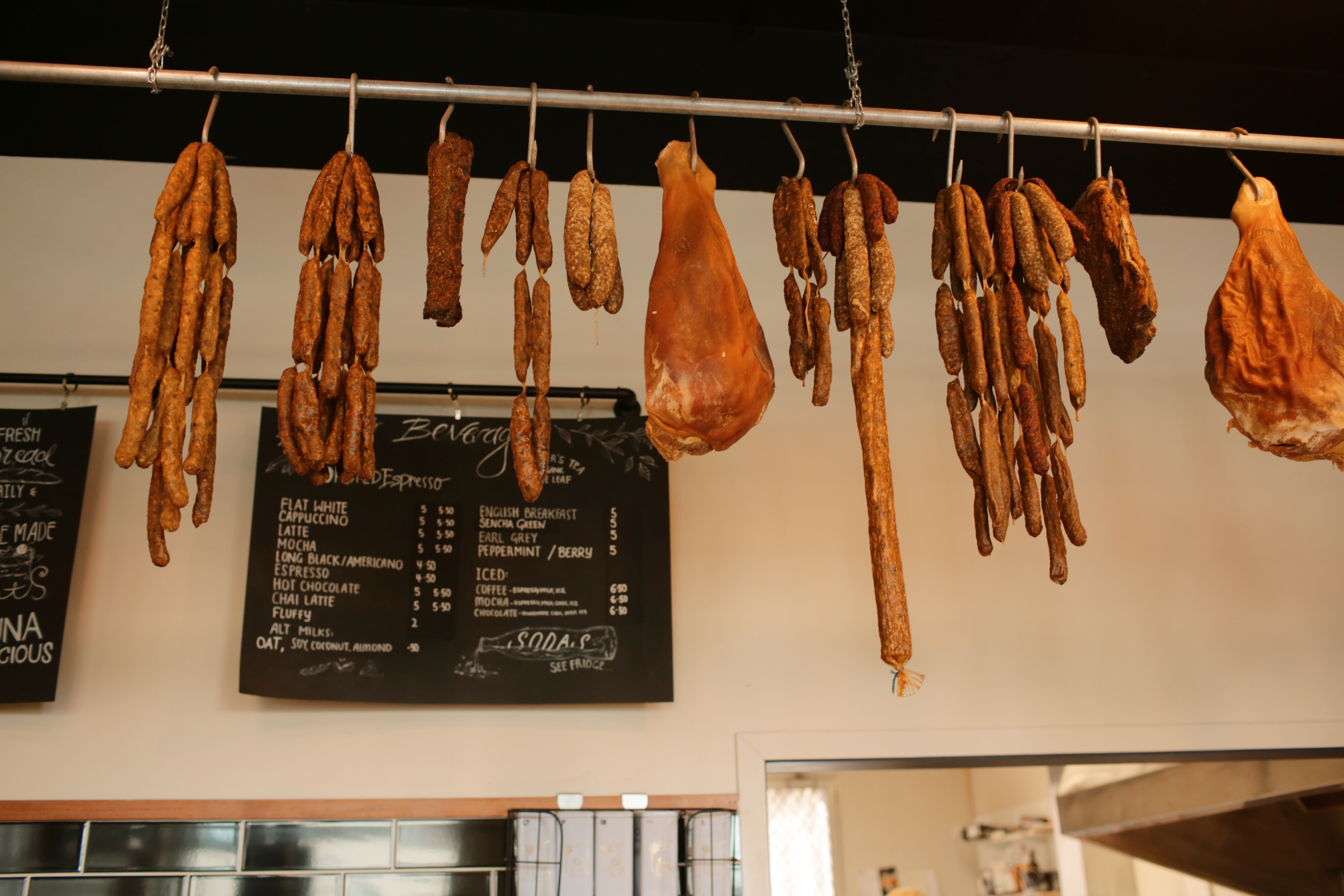 Selection of Te Puna deli cured meats hanging in their store.
