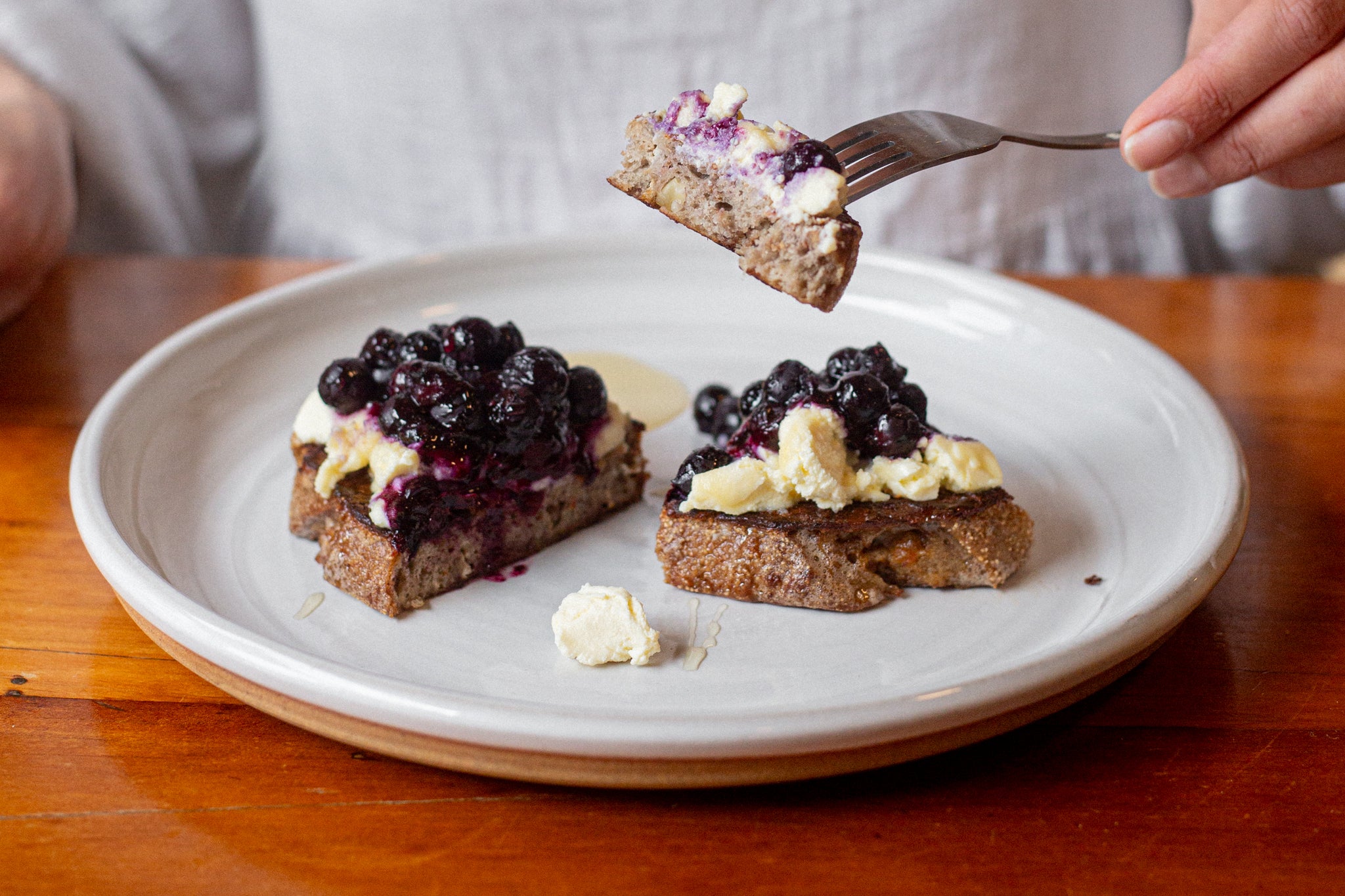 Fig & Walnut Sourdough French Toast topped with Ricotta and Blueberry on a plate