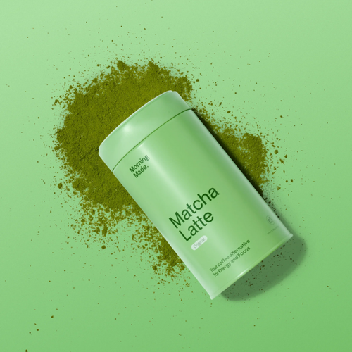 Green container of Matcha Latte powder on a green background