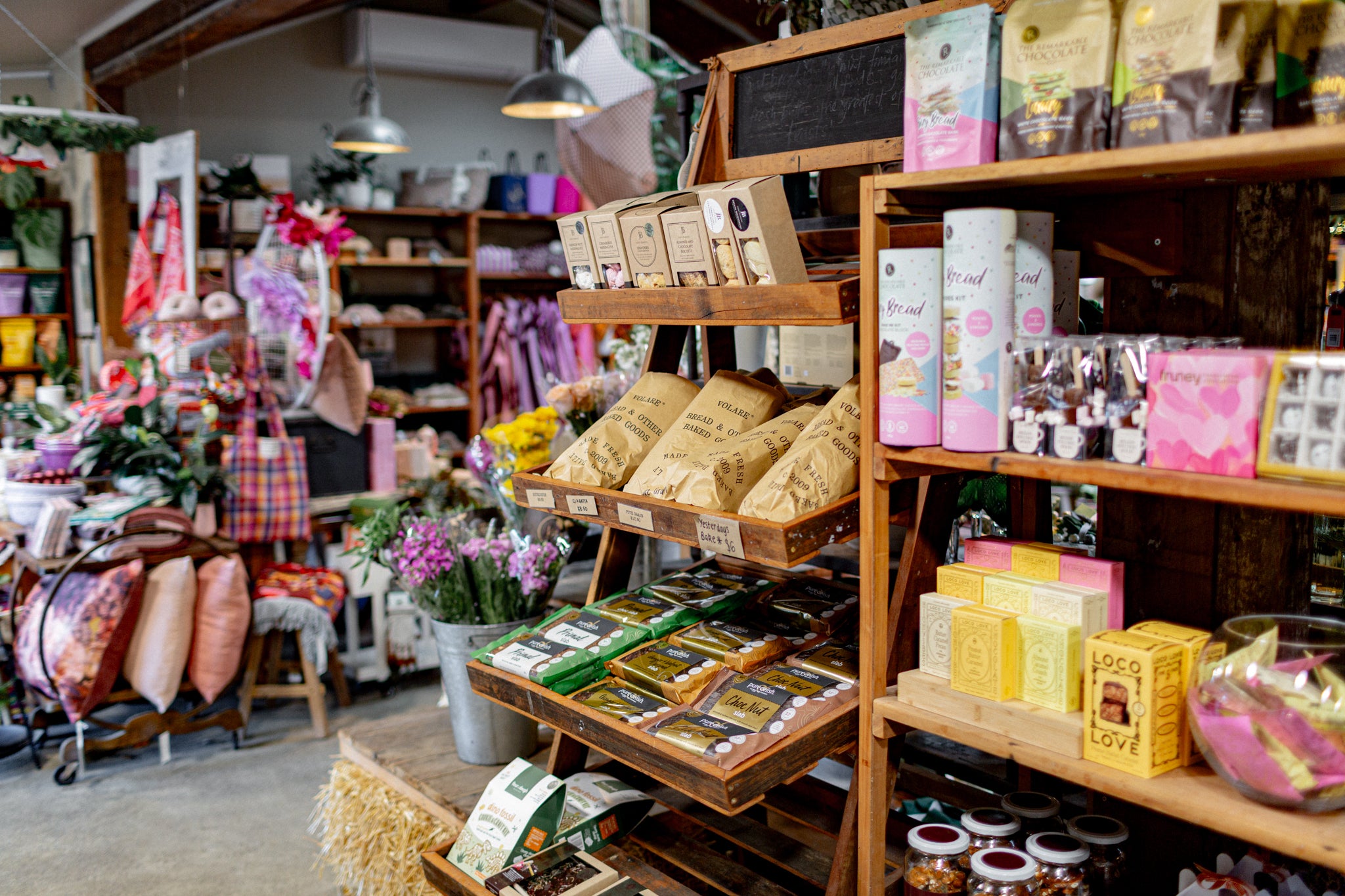Full shelves inside The Country Providore stocking sweets, chocolate and fresh Volare bread