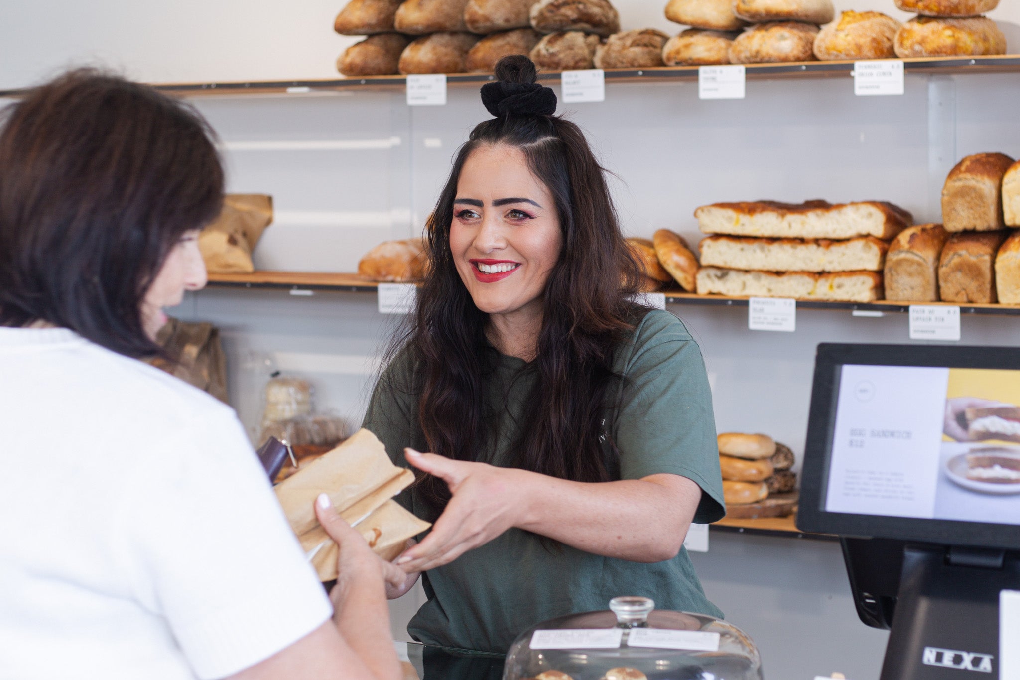 Volare regional retail manager Amy Berryman serving a customer at Main Bakery store
