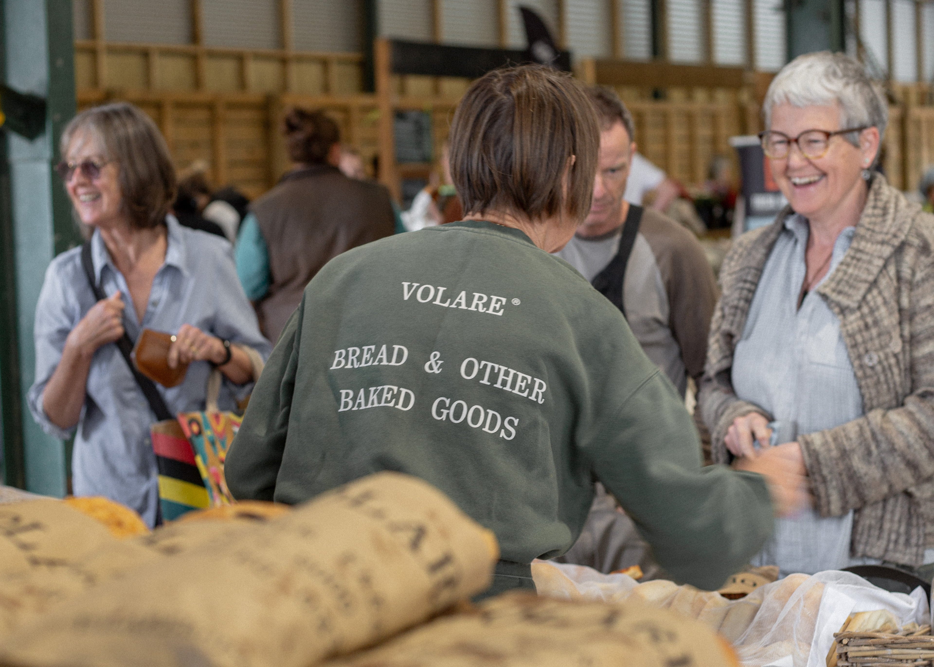Kay serving customers from the Volare Bread stand at the Farmers Market