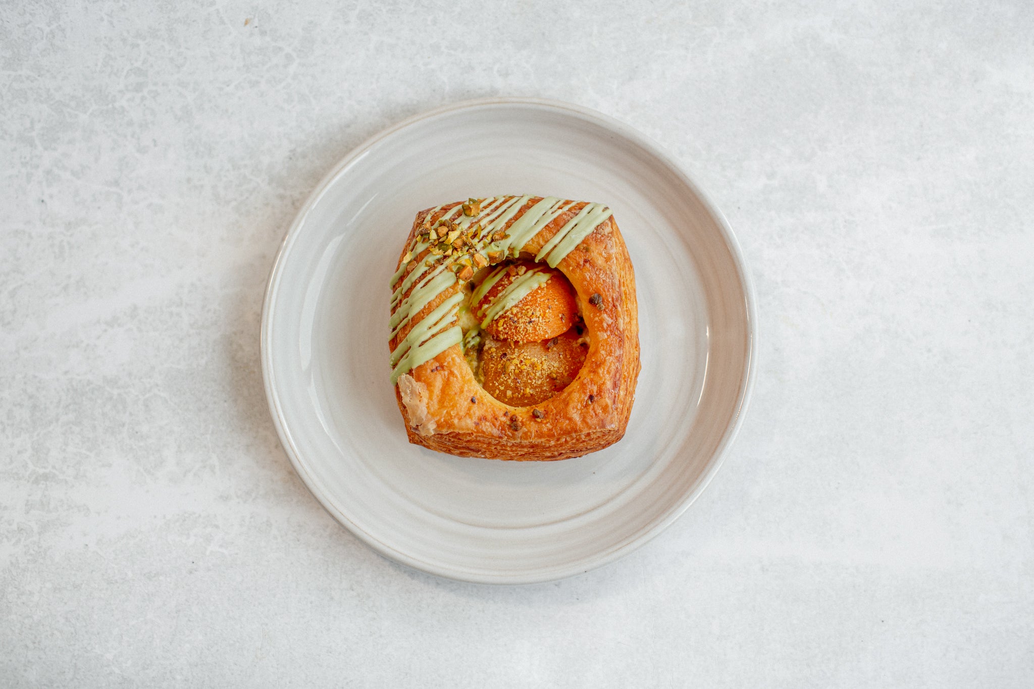 Volare Apricot & Pistachio Danish on a white plate