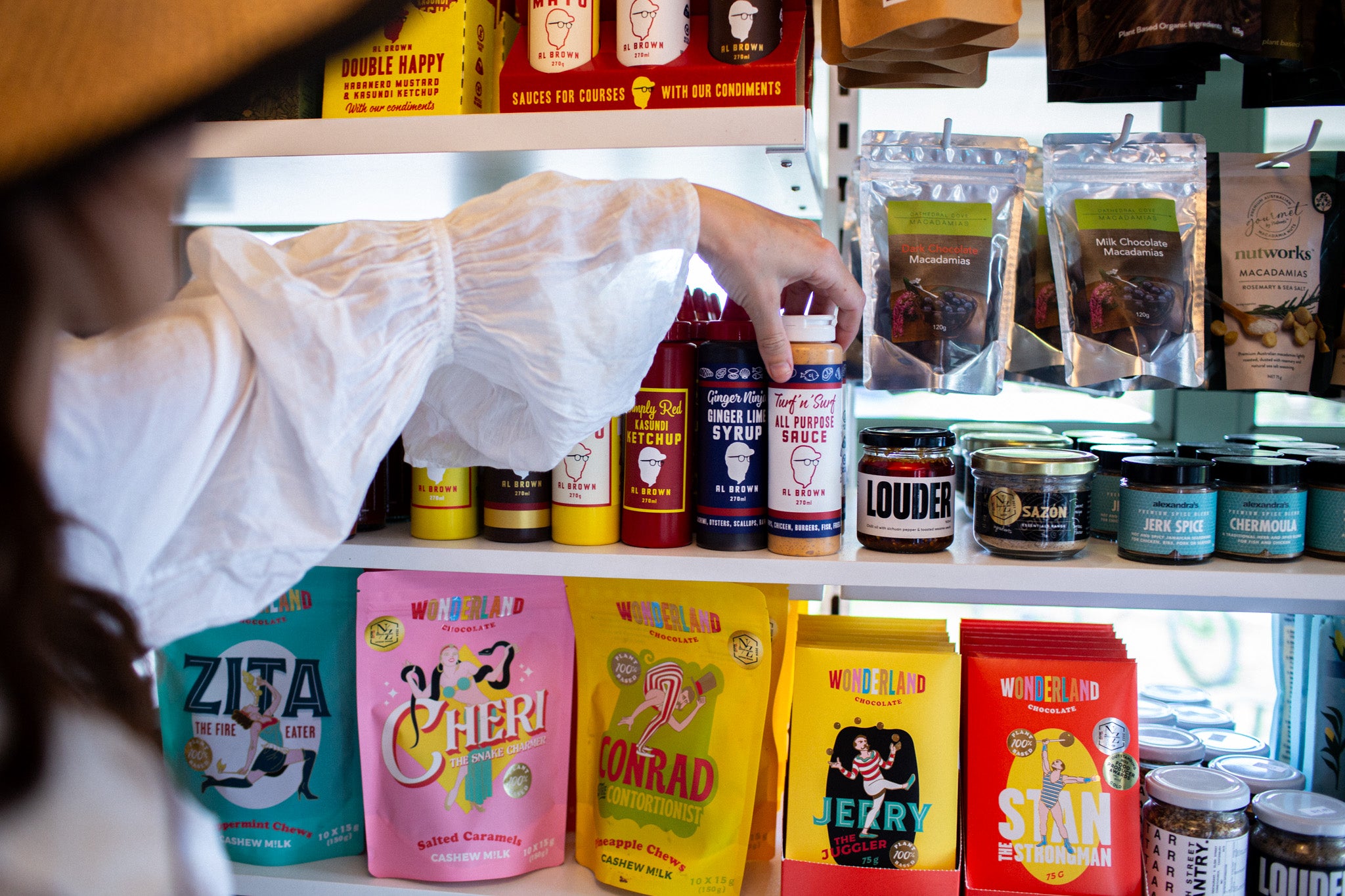 Shelf with Al Brown sauces inside Cove Beach Essentials. 