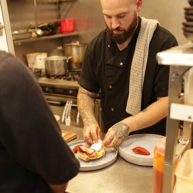 Chef at The General preparing Eggs Benedict using Volare San Francisco Sourdough.