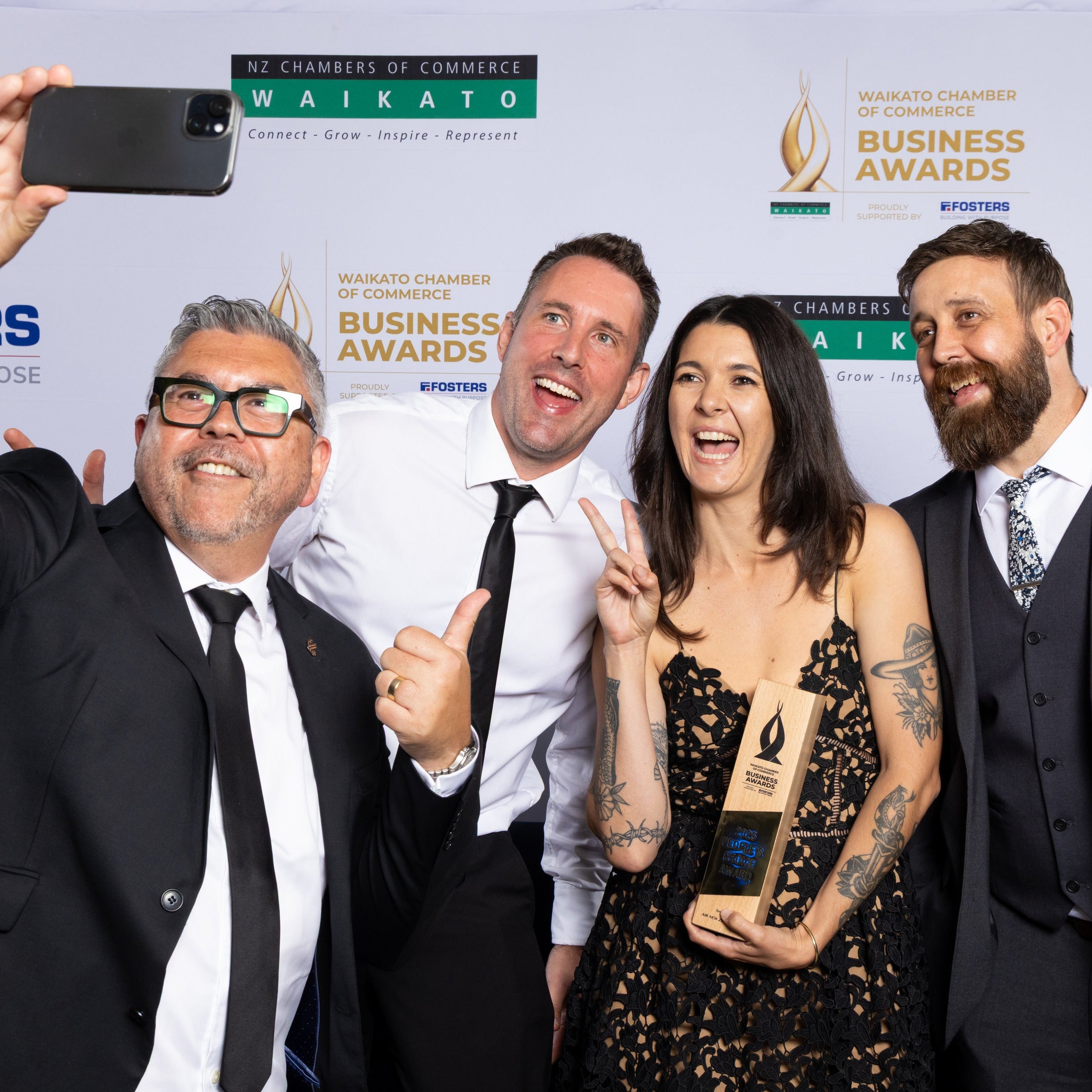 Holly, Ed, and Ryan posing for a selfie after winning the People