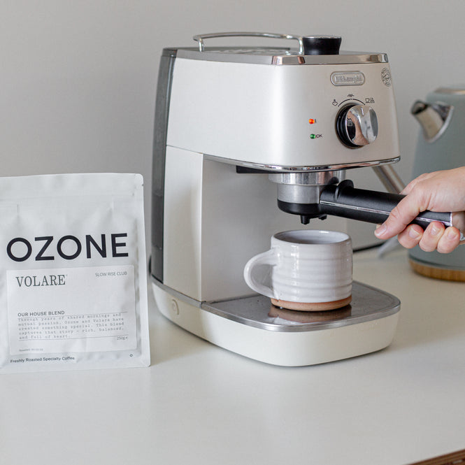 Espresso machine brewing a cup of Volares house blend coffee.