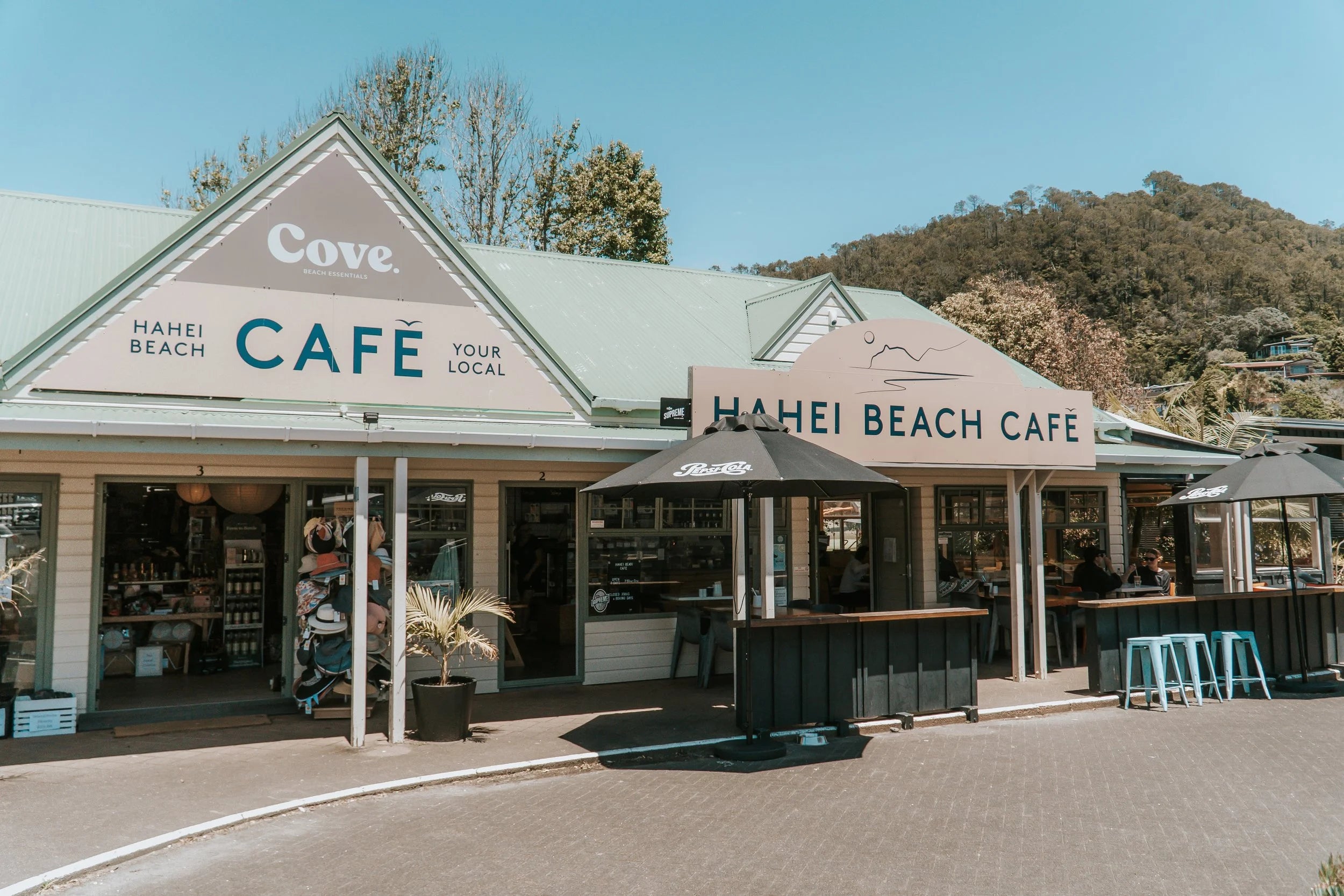 Hahei Beach Cafe with a clear sky and trees in the background