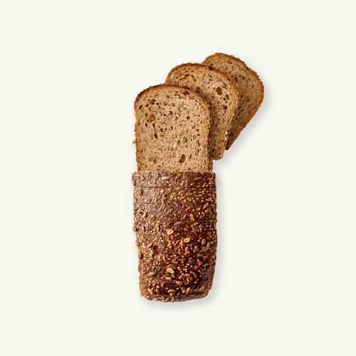 Loaf of Volare Grain with three slices cut from it on a white background