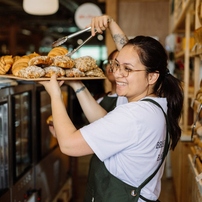 Person holding a tray of pastries at Volare bakery store in Made Markets 