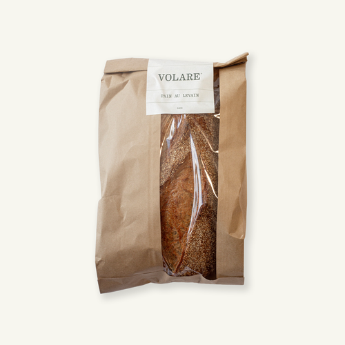 Sliced Volare Pain au Levain sourdough in a brown paper bag with clear window