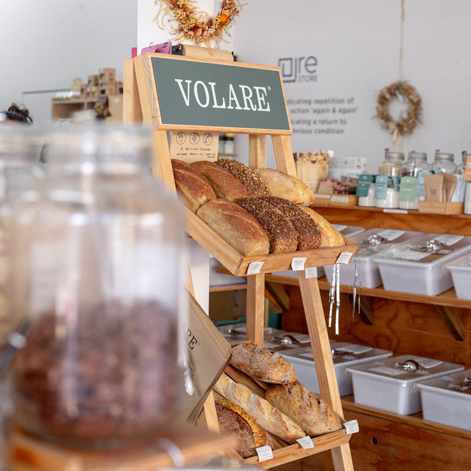 Stockist display of bread on a wooden stand with 