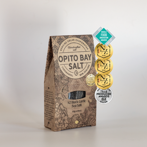 Opito Bay NZ Black Garlic Sea Salt packaging with certification badges on a light gray background