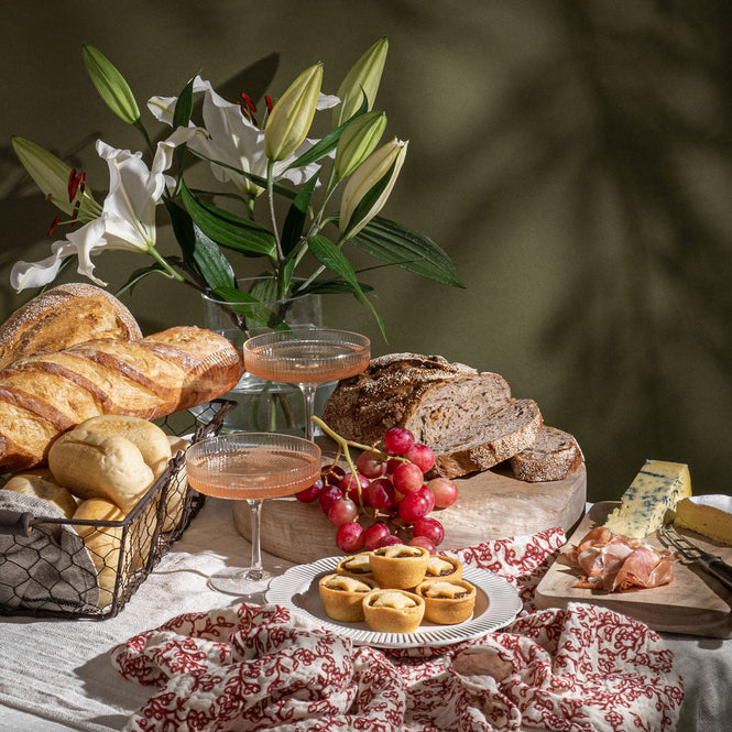 Volare Christmas Collection spread out on a table with champagne
