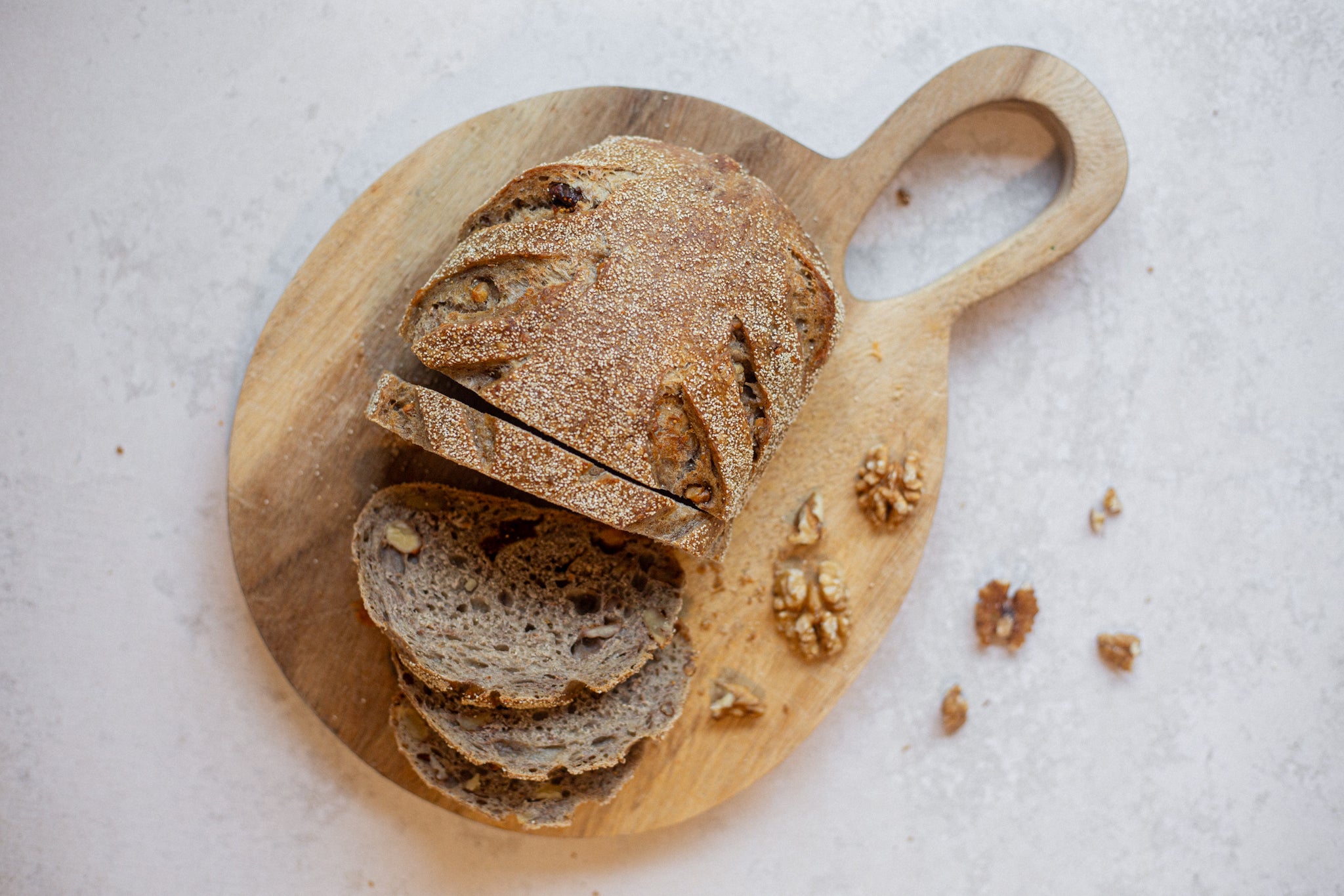 Volare Fig & Walnut Sourdough sliced on wooden chopping board